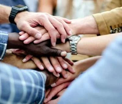 Hands joined together in a photograph from Cognitive Renovations’ supplied website materials