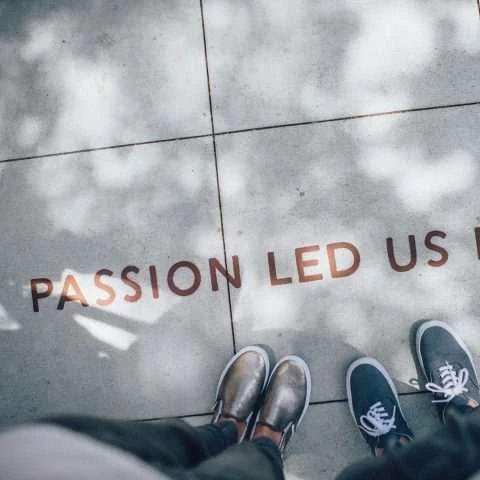 Sidewalk photograph reading ‘Passion led us’ from Cognitive Renovations’ About page