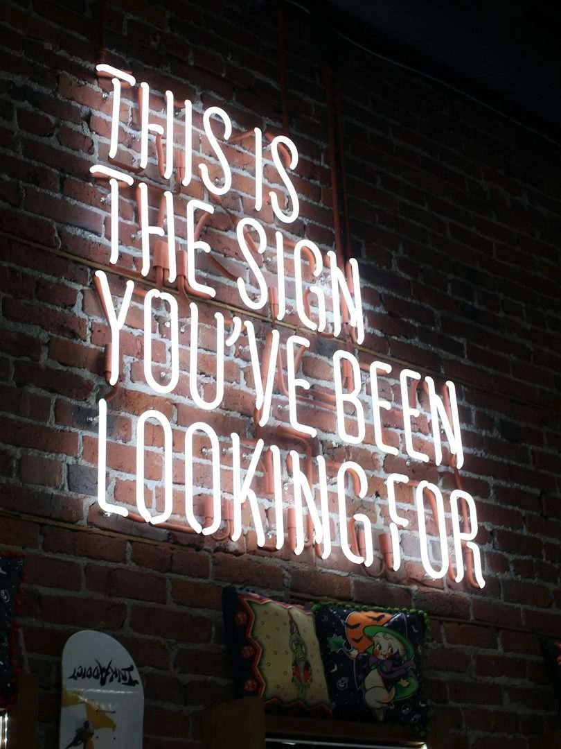 Neon sign reading ‘This is the sign you’ve been looking for’ from Cognitive Renovations’ About page