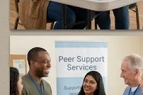 A peer worker welcomes people into a community resource event